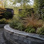 Small garden with a patio, planted borders, and a narrow path